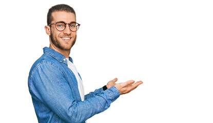 Young caucasian man wearing casual clothes pointing aside with hands open palms showing copy space, presenting advertisement smiling excited happy