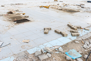 destroyed interior decoration. dilapidated building. debris on the floor. former car service and car wash area