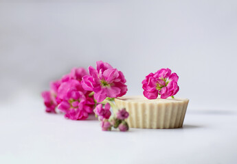 Handmade bath soap with flowers on a white background