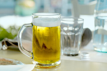 Cold beer served in outdoor cafe or restaurant on hot summer day