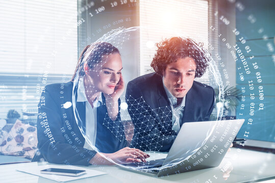 Businessman and attractive businesswoman. Working on laptop conducting a research to hire high qualified employees for international projects and taking notes. Concept of HR and digital interface