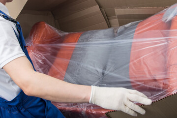 the mover unpacks the upholstered furniture, after delivery