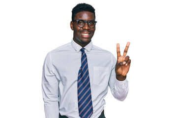 Handsome business black man wearing white shirt and tie smiling with happy face winking at the camera doing victory sign. number two.