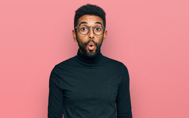 Obraz premium Young african american man wearing casual clothes scared and amazed with open mouth for surprise, disbelief face