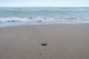 Fototapeta na wymiar Solitary stone on the beach.