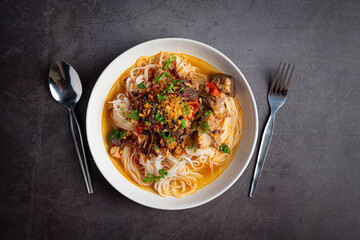 Rice noodles in fish curry sauce with vegetables