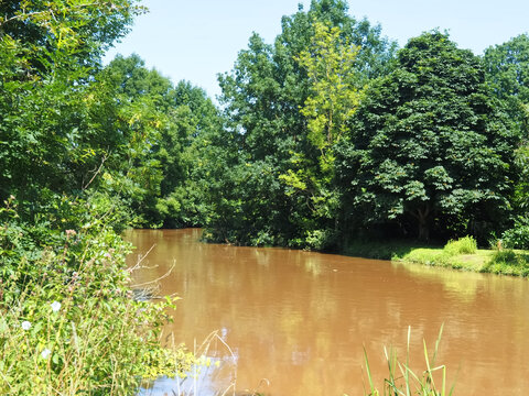 Brown and muddy Erft river in Germany after the flood