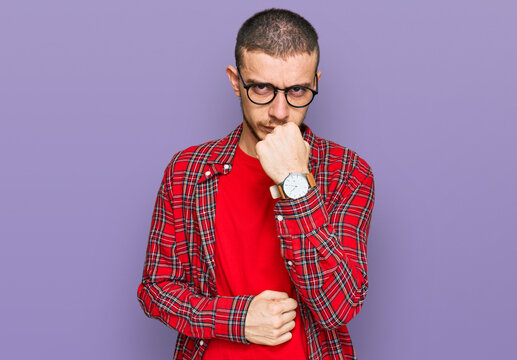 Hispanic young man wearing casual clothes ready to fight with fist defense gesture, angry and upset face, afraid of problem