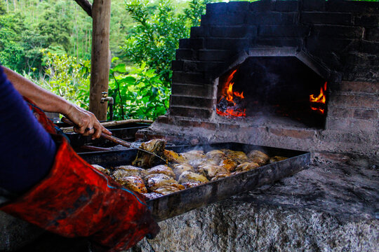 cooking delicious chicken in a brick and cement oven in the middle of the mountains in rural Puriscal Costa Rica