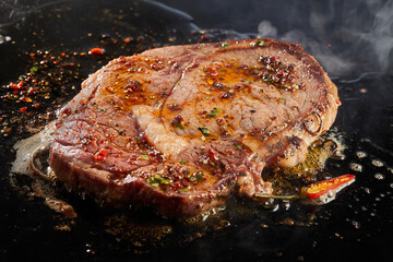 Juicy beef steak cooking in oil