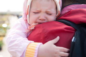 crying baby on mother shoulder