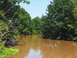 Brown and muddy Erft river in Germany after the flood