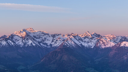 Fototapeta na wymiar Snowy mountain range during sunrise