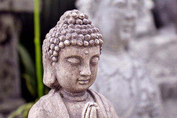 Buddha stone statue close up. Traditional Buddhist sculpture for home or temple decoration