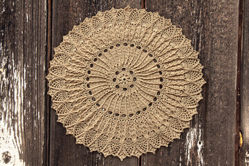 Beautiful closeup crochet doily on old wooden background - obrazy, fototapety, plakaty