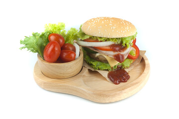 Pork hamburger Homemade with grilled bacon contains vegetables, cheese, lettuce, onion, chilli, spices in a wooden dish isolated on white backgroud