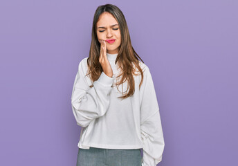 Young brunette woman wearing casual turtleneck sweater touching mouth with hand with painful expression because of toothache or dental illness on teeth. dentist