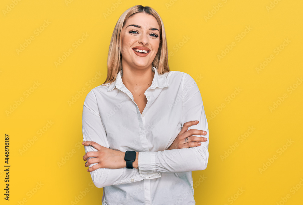 Wall mural young caucasian woman wearing casual clothes happy face smiling with crossed arms looking at the cam