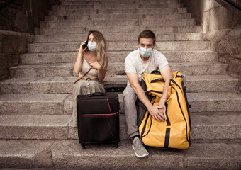 Tourist couple with protective face mask worried about covid test results before travel abroad