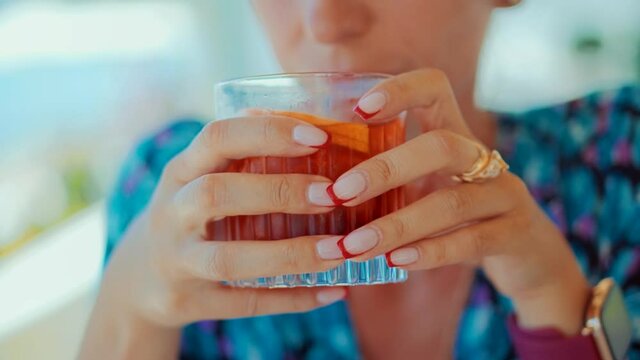 Woman Drinking Alcohol Negroni Cocktail In Bar.Summer Holiday Vacation Travel On Sea.Girl Hiding From Sun Drinking Sipping For Healthy Refreshing Cocktails.Lady Drinking Negroni Cocktail.