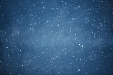 Fototapeta premium blue snowfall bokeh background, abstract snowflake background on blurred abstract blue