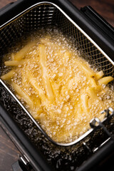 friing potatos in fryier  for french fries