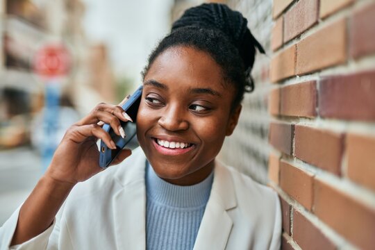 Young african american businesswoman smiling happy talking on the smartphone at the city.