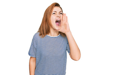 Fototapeta premium Young caucasian woman wearing casual clothes shouting and screaming loud to side with hand on mouth. communication concept.