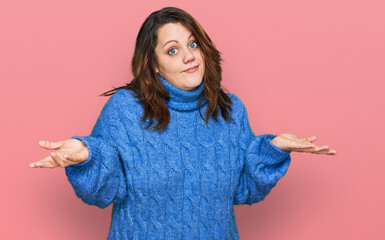 Young plus size woman wearing casual clothes clueless and confused expression with arms and hands...