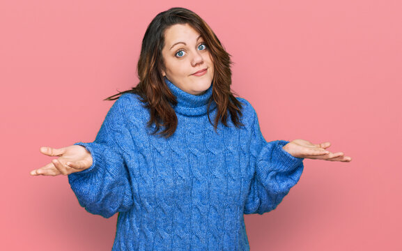 Young plus size woman wearing casual clothes clueless and confused expression with arms and hands raised. doubt concept.