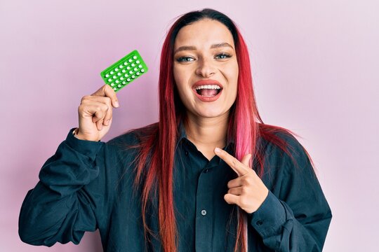 Young Caucasian Woman Holding Birth Control Pills Smiling Happy Pointing With Hand And Finger