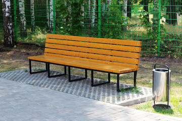 New wooden bench in the park in summer