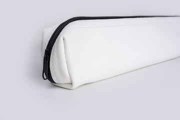 Fototapeta na wymiar White stationery pouch with zipper on a white