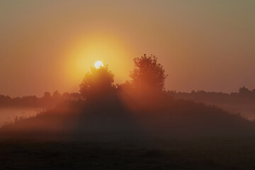 Sunrise over the cliff. morning haze at dawn on a cliff in summer. Freshness.