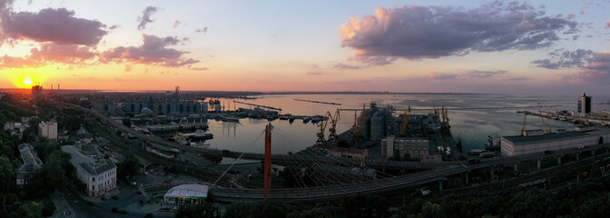 Sun set panorama of urbane landscape with sea por in Odessa Ukraine. Drone footage, natural light..