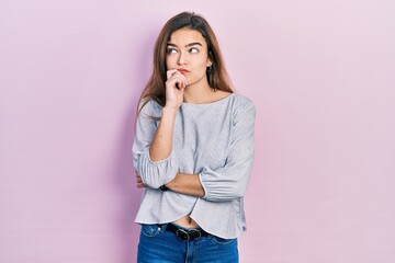 Young caucasian girl wearing casual clothes serious face thinking about question with hand on chin, thoughtful about confusing idea