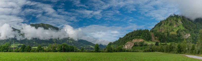 Hills and valley near Sankt Johann im Pongau with fog and green meadows