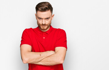 Young redhead man wearing casual clothes skeptic and nervous, disapproving expression on face with...