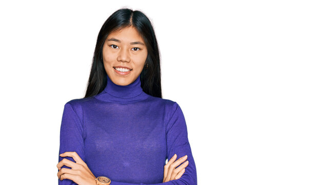 Beautiful young asian woman wearing casual clothes happy face smiling with crossed arms looking at the camera. positive person.