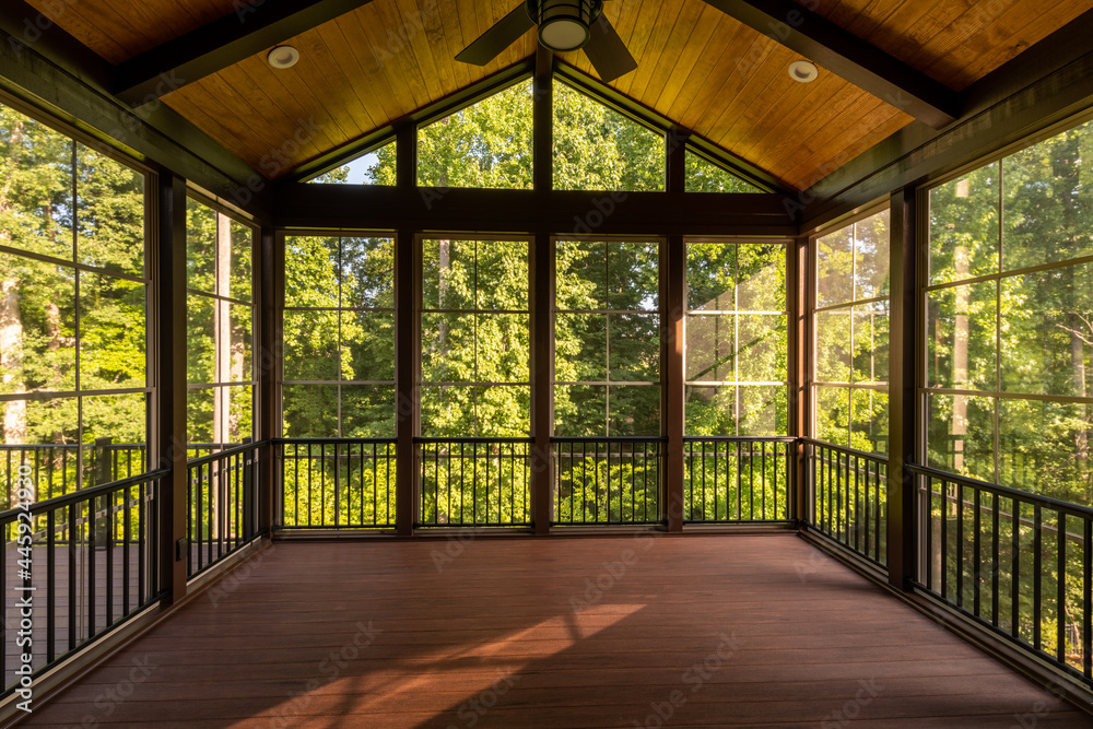 Wall mural modern new screened porch with plastic windows and composite floor with summer woods in the backgrou