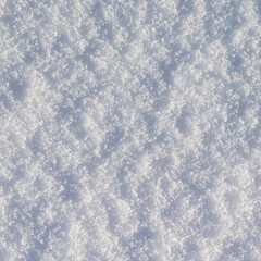 Obraz premium Winter snow background, ice crystals sparkling on snow, christmas texture, sparkling snowflakes in snowdrift.