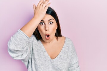 Young hispanic woman wearing casual clothes surprised with hand on head for mistake, remember error. forgot, bad memory concept. - obrazy, fototapety, plakaty