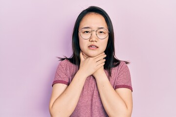 Young chinese girl wearing casual clothes and glasses shouting and suffocate because painful strangle. health problem. asphyxiate and suicide concept.