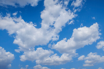 Naklejka na ściany i meble Background image: white clouds in a blue sky in clear weather