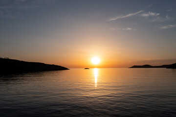 Fototapeta na wymiar Sunset over calm sea, orange color sky background. Aerial drone view, Greece
