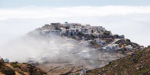 Sifnos island, Cyclades Greece. On top of hill through fog Kastro ancient village.