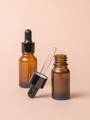 Two bottles filled with medicines on a beige background.