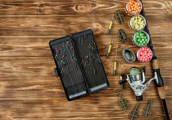 Accessories for carp fishing and fishing baits on wooden planks with copy space