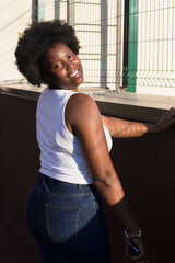 portrait of a happy African-American woman on the street in summer