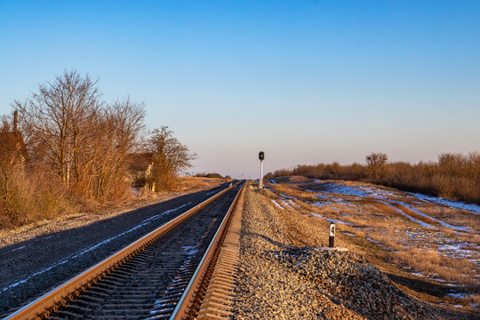 Semaphore: green light is on. Rails railroad at sunset. Semaphore green light. Rails railroad at sunset. Topic: railroad